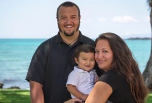 Family holding a toddler