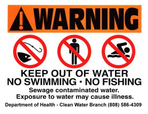 A sign with the following words. Warning. Keep out of water. No swimming. No fishing. Sewage contaminated water. Exposure to water may cause illness. Department of Health. Clean Water Branch (808) 586-4309