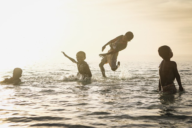 children playing in the ocean