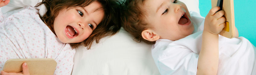 Photo: Two toddlers lying side by side reading