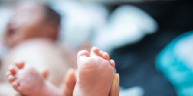 Photo: Father holding baby's feet