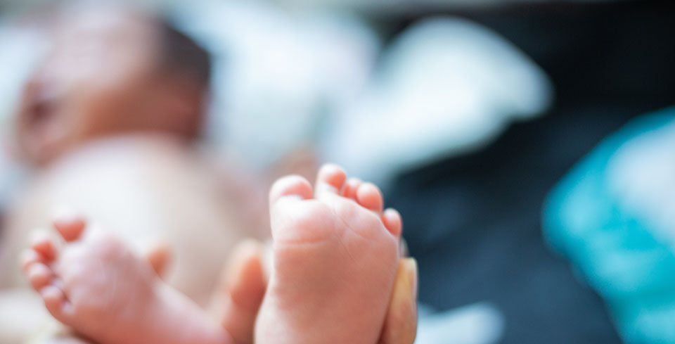 Photo: Father holding baby's feet