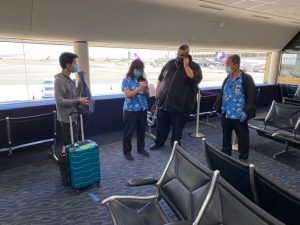 arriving travelers at airport gate filling out a form