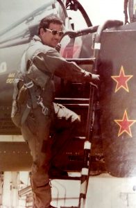 Photo: Bill Rodrigues climbing aboard a military aircraft