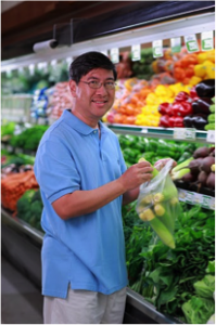 Man selecting fresh produce in grocery store. 