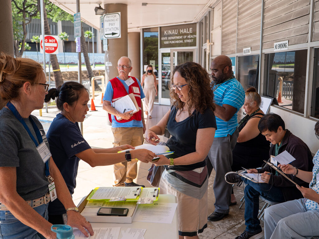 Staff are helping other people fill out forms