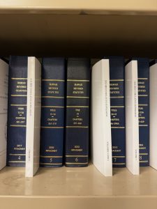 Bookshelf that includes bound copies of the Hawaii Revised Statutes